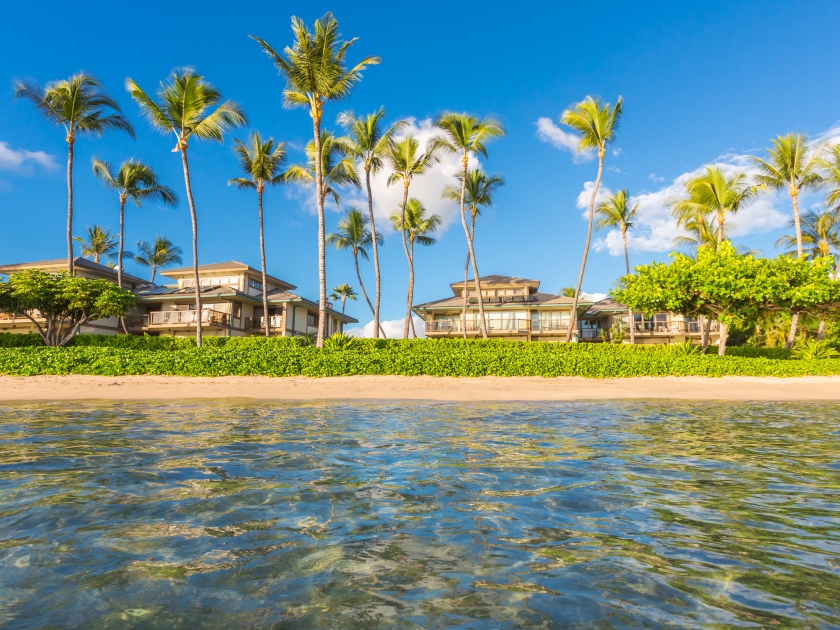 Vacation cottages on the beach with palms, Maui, Hawaii.