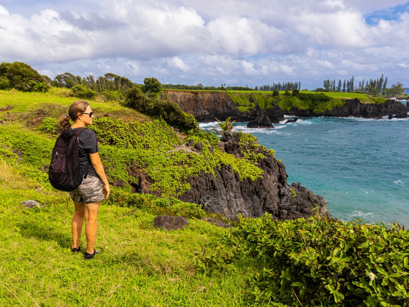 Female Hiker on The Rugged Shoreline Along The Maka Alae Coast, Hana, Maui, Hawaii, USA