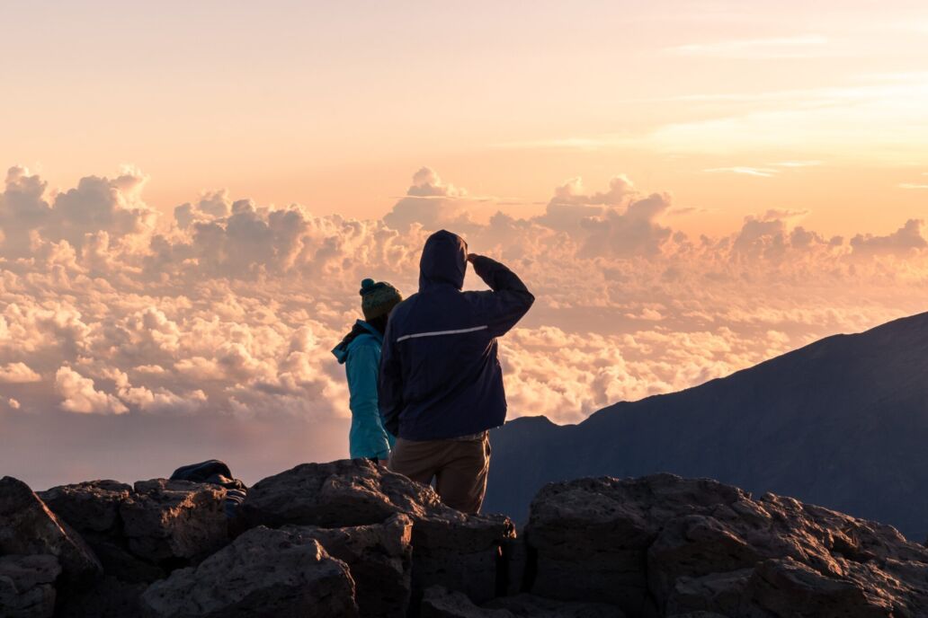 Young,Couple,Watching,A,Colorful,Sunrise,On,Top,Of,A