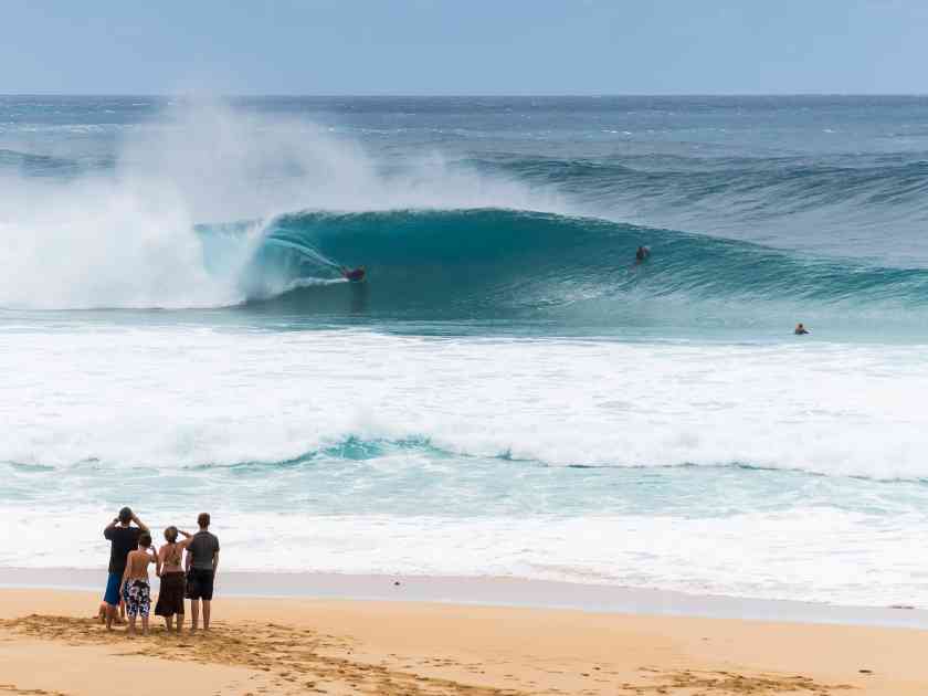 People watch body boarder at Banzai Pipeline