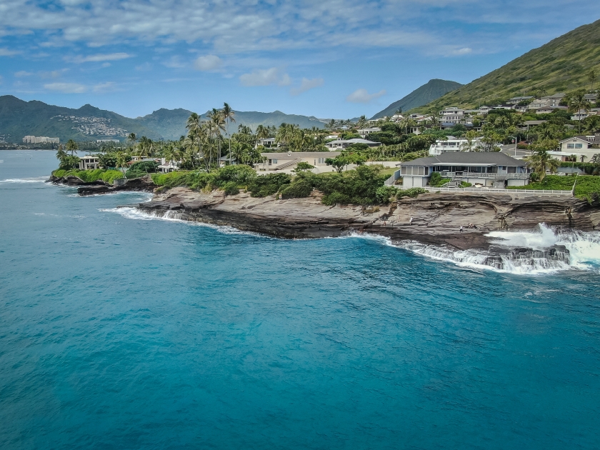 China Walls ocean front homes and waves breaking on the cliffs in Hawaii Kai, Oahu Hawaii.