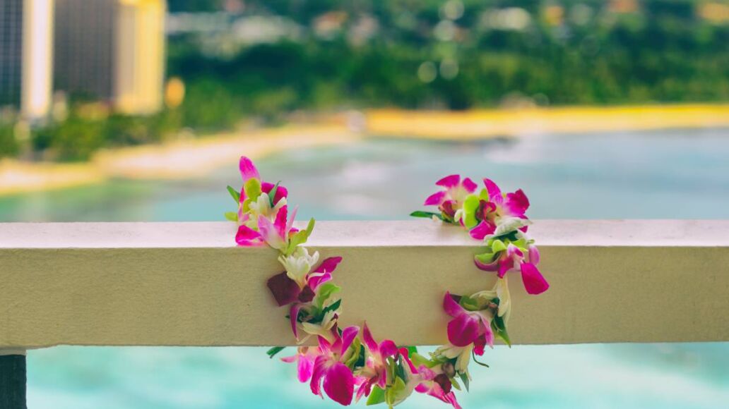 Hawaii background hawaiian flower lei with Waikiki beach landscape.