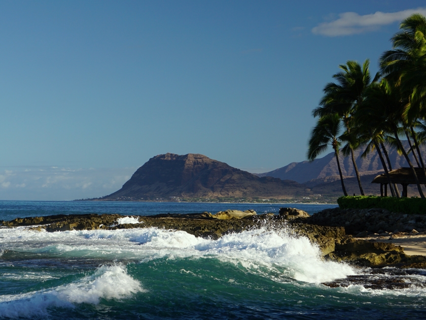 View of a beach in Ko Olina Lagoons along Oahu's west shore, with the Waianae Mountains in the distance.