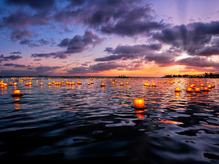 Floating Lantern Memorial Day Festival Honolulu, HI where lanterns are released in the lagoon with personalized messages to loved ones lost at sunset