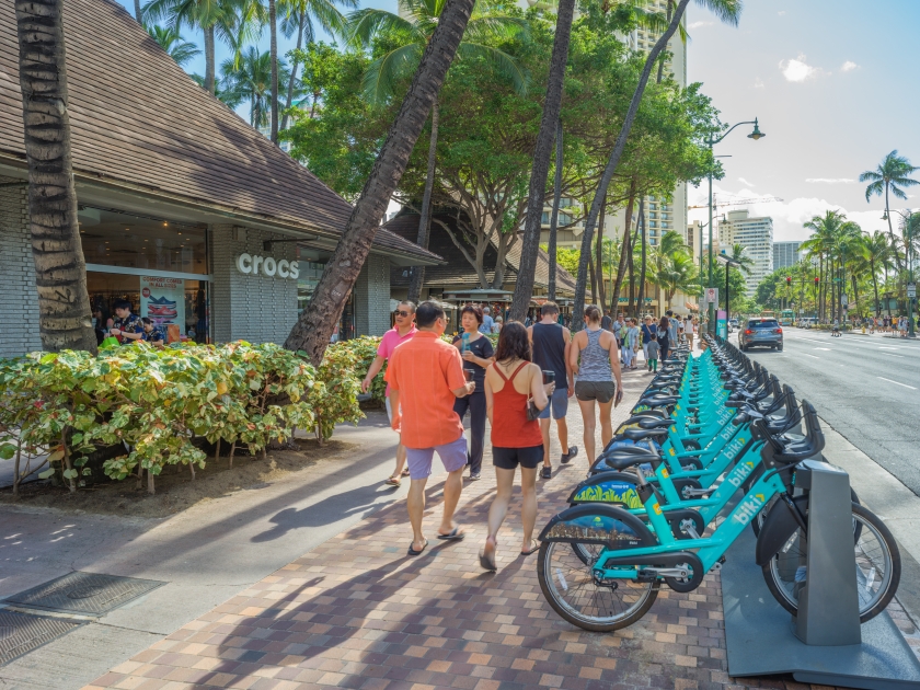 Honolulu, Hawaii, USA, Nov. 15, 2017. Waikiki tourists take notice of the new Biki Bicycle rentals along the main route to the beach and surf.