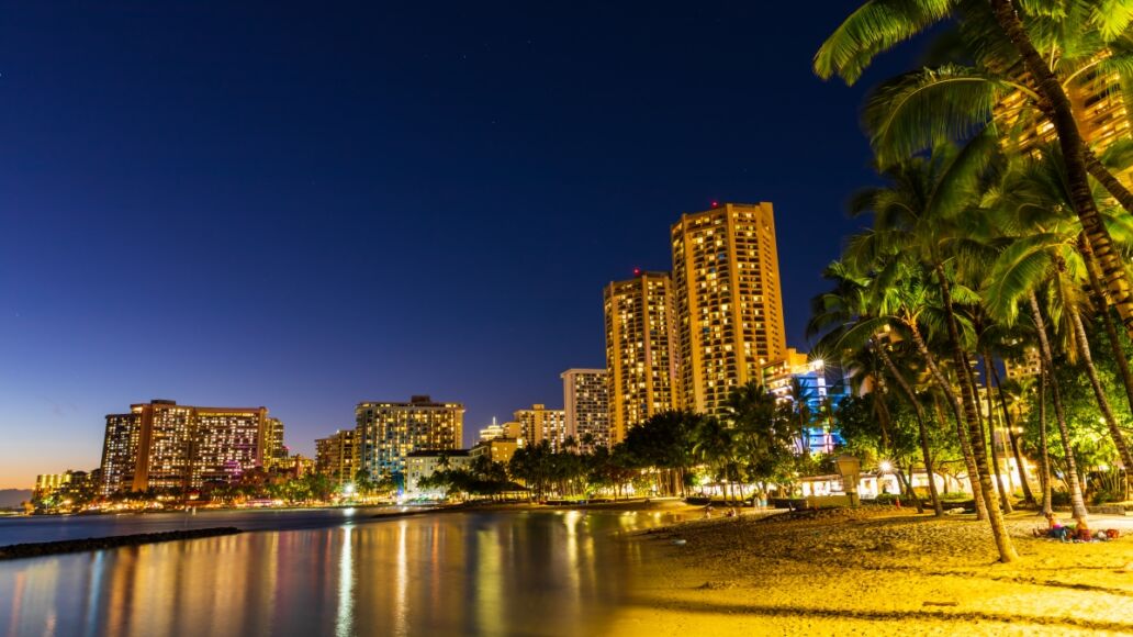 Beautiful view of Honolulu skyline and Waikiki beach at night in the island of Oahu, Hawaii, USA. Long exposure shot.