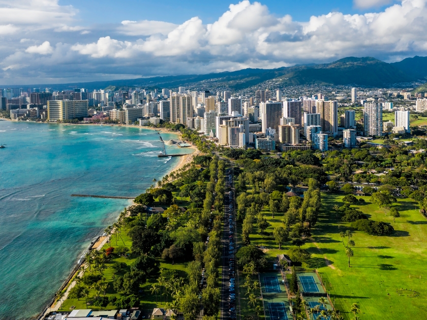 Aerial view of Waikiki skyline with park district leading to Honolulu city. Afternoon light. Oahu Island, Hawaii