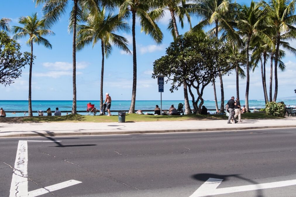 Kalakaua Avenue along Waikiki beach in Honolulu, Hawaii. Waikiki beach is neighborhood of Honolulu, best known for white sand and surfing.