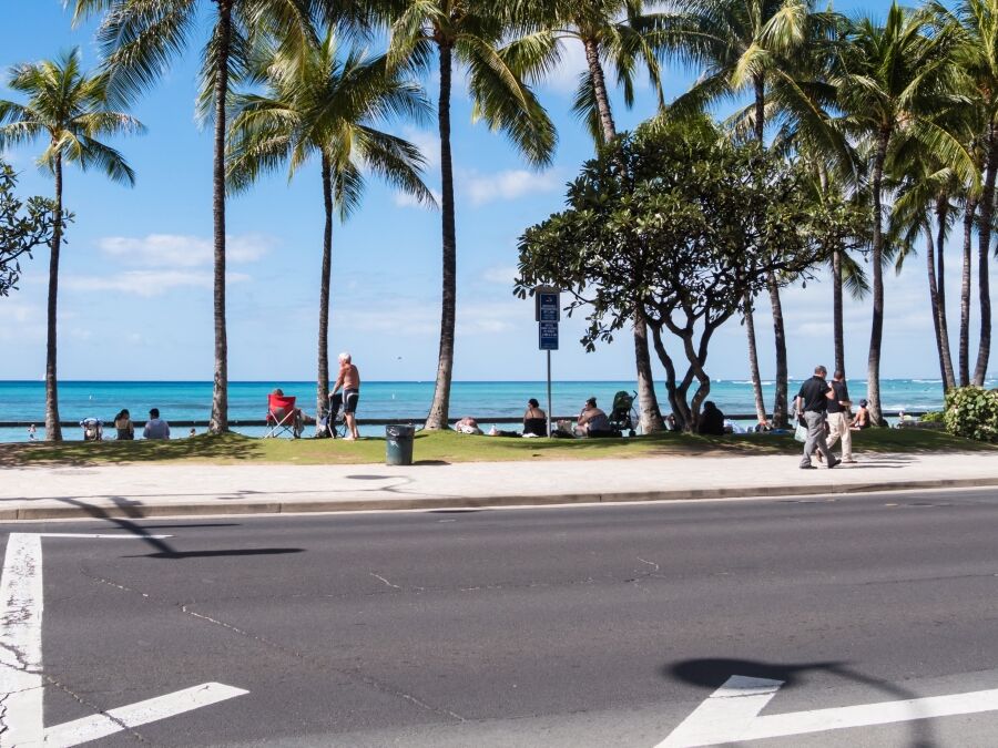 Kalakaua Avenue along Waikiki beach in Honolulu, Hawaii. Waikiki beach is neighborhood of Honolulu, best known for white sand and surfing.