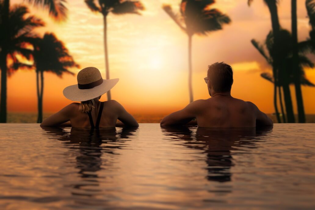 Couple,Enjoying,Sunset,From,Infinity,Pool,At,Tropical,Bali,Island